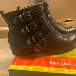 Bare traps all manmade black bootie with gunmetal buckles.
